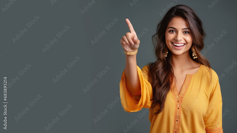 Happy indian woman pointing her finger at copy space for promotion - obrazy, fototapety, plakaty 