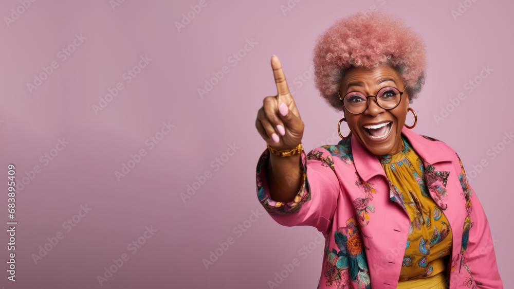 Happy senior afro woman points her finger at copy space for promotion - obrazy, fototapety, plakaty 