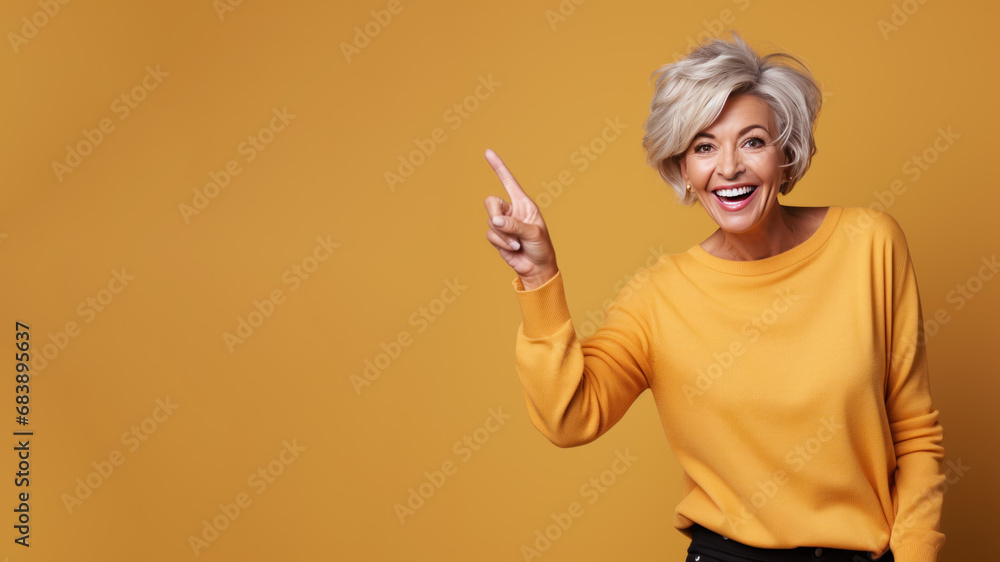 Happy senior blonde woman point her finger at copy space for promotion Happy senior blonde woman point her finger at copy space for promotion
