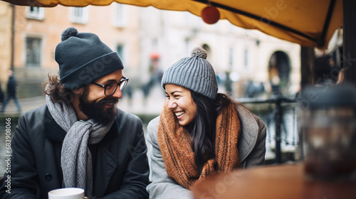 Happy Couple Enjoying Warm Coffee Outdoors on a Chilly Day in Urban Setting photo