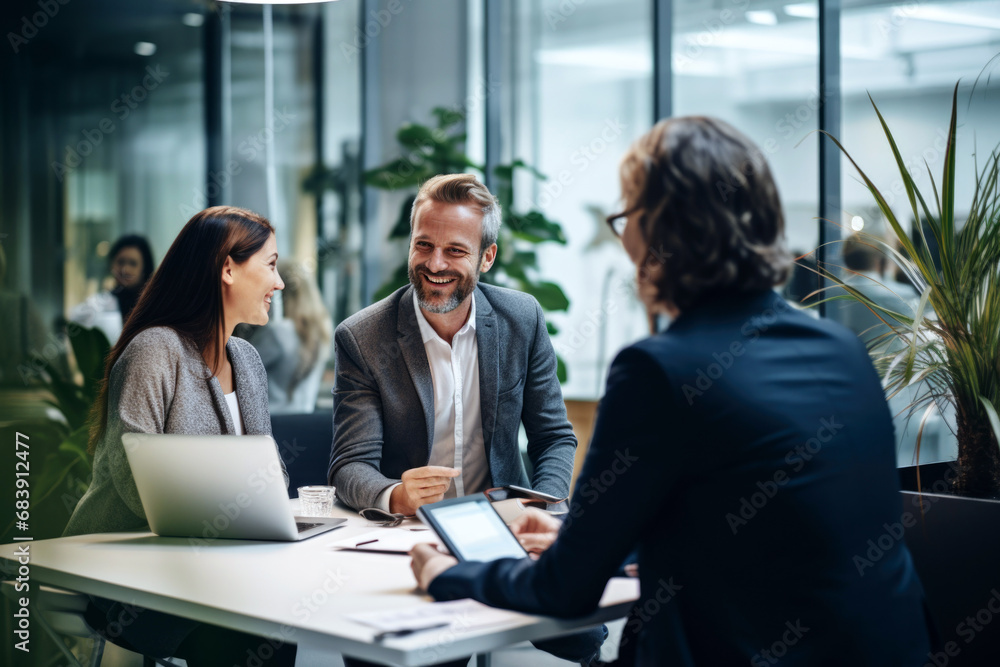 Group of Business Professionals Discussing Strategy in Office Meeting. Businesspeople having a productive business meeting indoors. Group of Business Professionals Discussing Strategy in Office Meeting. Businesspeople having a productive business meeting indoors.