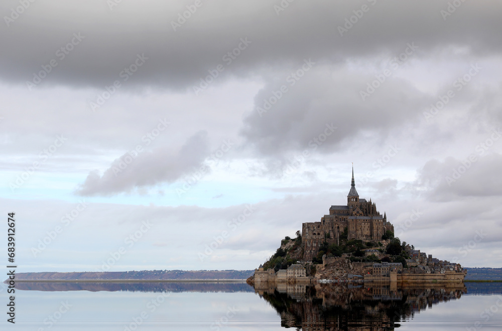 Reflection on the water of the ancient Abbey of Mont Saint Michel in the Normandy region of France