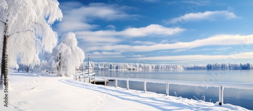 On a cold winter day in Tampere, Finland, a snowy white landscape greeted the eye, as the sun shone brightly over the frozen lake, its sparkling surface contrasting against the snow-covered pier