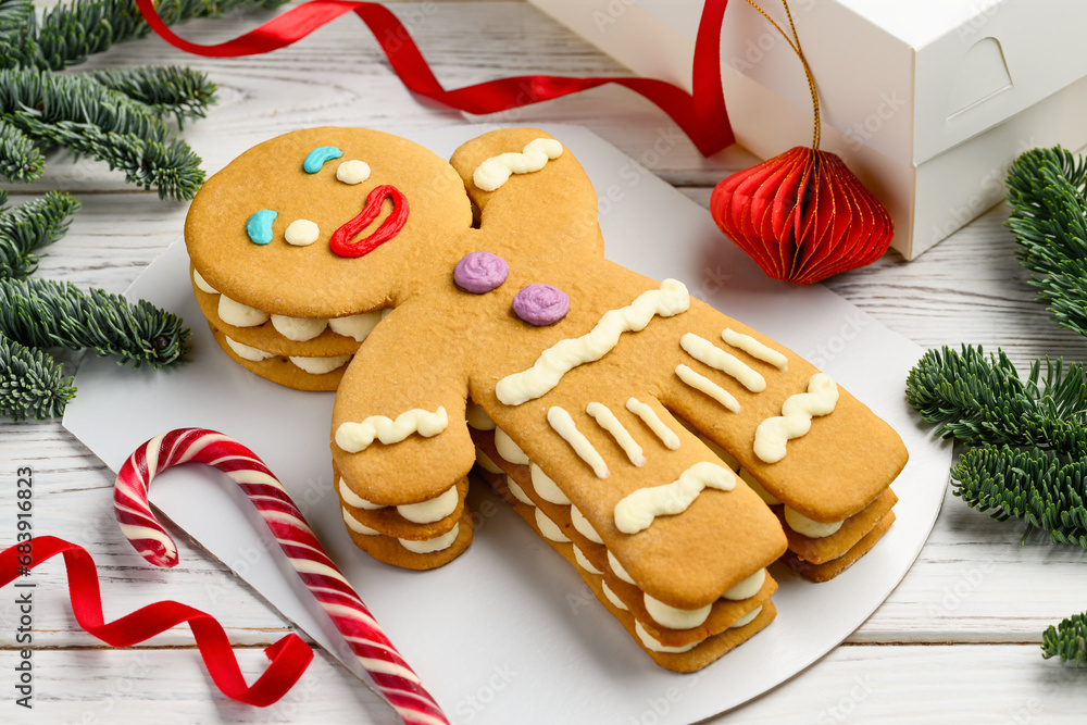 Christmas honey gingerbread man cake on a white table. New Year's festive dessert. Selective focus Christmas honey gingerbread man cake on a white table. New Year's festive dessert. Selective focus