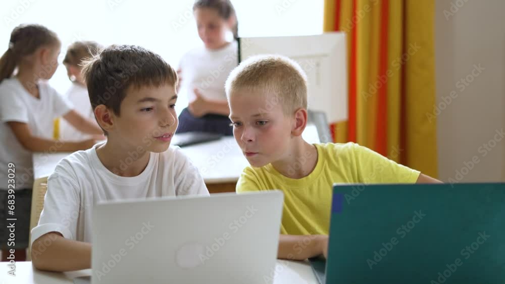 Happy team of friend.Children education at school with laptop.Children play together at computer as team.Online games for teaching teamwork at school in classroom.Online work learning laptop at school Happy team of friend.Children education at school with laptop.Children play together at computer as team.Online games for teaching teamwork at school in classroom.Online work learning laptop at school