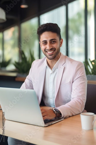 Happy young business man entrepreneur in office using laptop at work, smiling professional male company executive wearing suit working on computer at workplace. generative AI