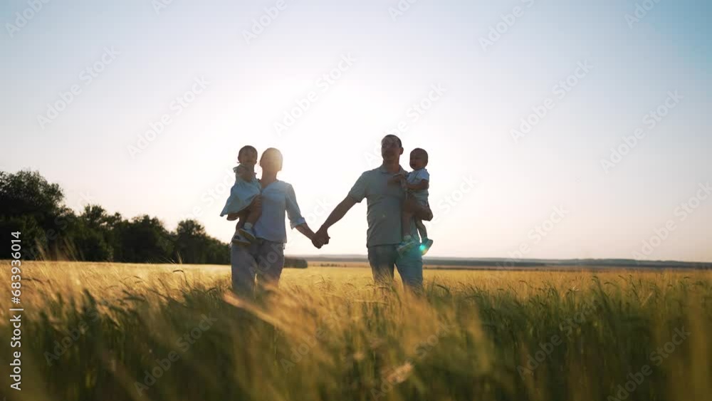 Happy family.group of people walk together holding hand in wheat field at sunset.family hold babies in their arms.Family day outdoors in summer in wheat field.Silhouette of happy family in wheat field Happy family.group of people walk together holding hand in wheat field at sunset.family hold babies in their arms.Family day outdoors in summer in wheat field.Silhouette of happy family in wheat field