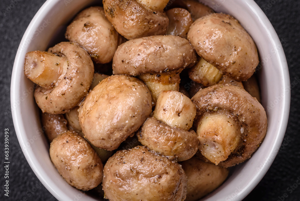 Delicious juicy whole champignons baked on the grill with salt and spices Delicious juicy whole champignons baked on the grill with salt and spices