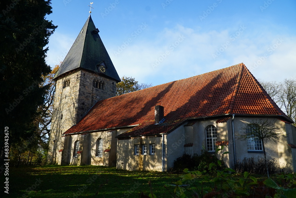 Fototapeta premium The Evangelical Lutheran village church of St. Cyriakus, Simon and Judas in the village Basse, Hanover region, Lower Saxony, Germany. It was built around the year 1100.