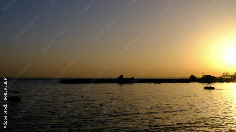 slowly floating sea cliffs and moving boat at sunset, slow motion in 4k resolution slowly floating sea cliffs and moving boat at sunset, slow motion in 4k resolution