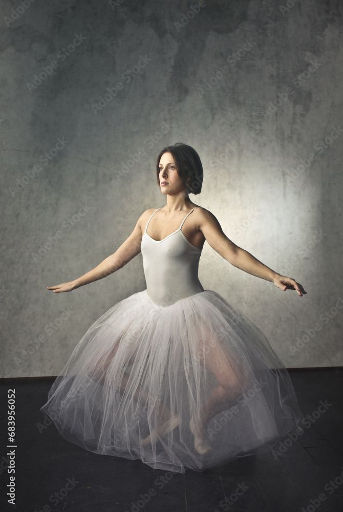 Naklejka premium ballerina during an exercise. studio shot