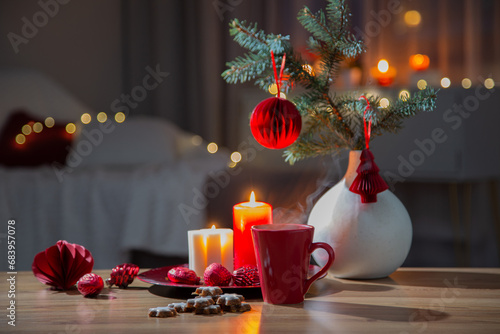 hot drink in red cup with christmas decorations at home