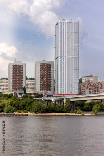 skyscraper against the background of a bridge over the river close-up in summer