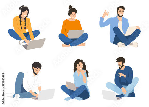 Group   students is sitting on the grass with a laptop. Education concept