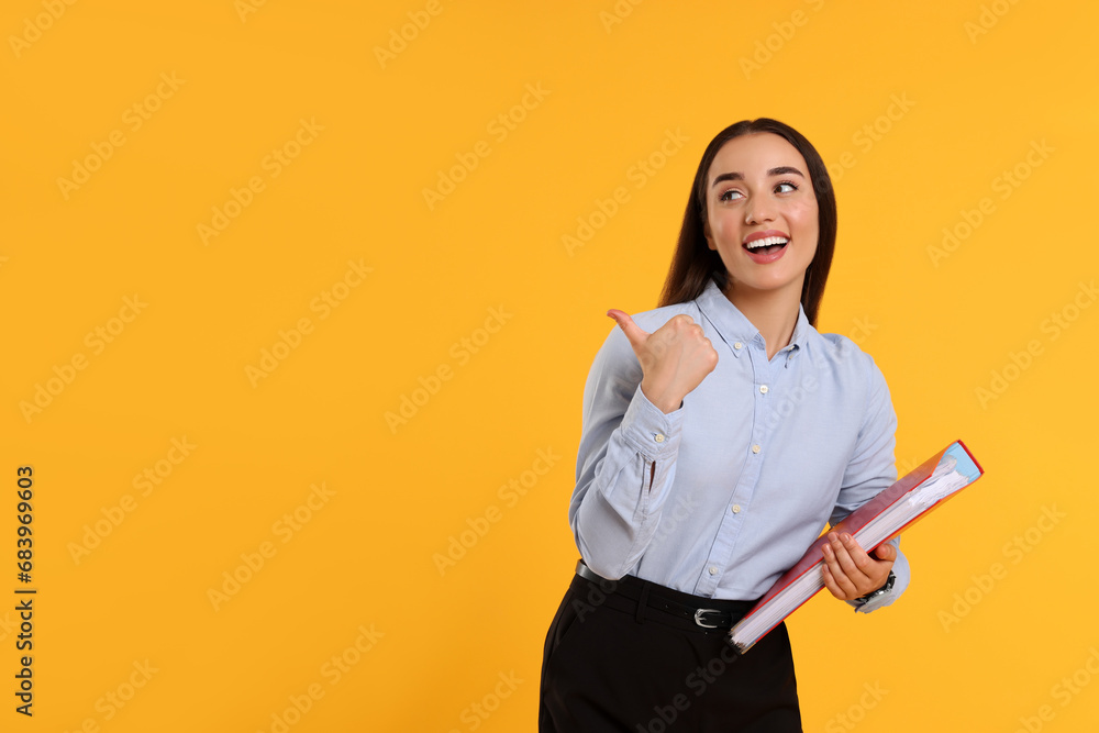 Happy woman with folder on orange background, space for text Happy woman with folder on orange background, space for text