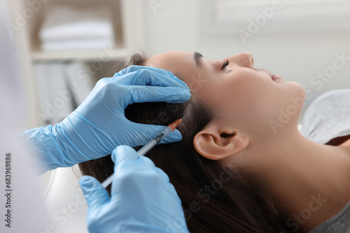 Trichologist giving injection to patient in clinic  closeup