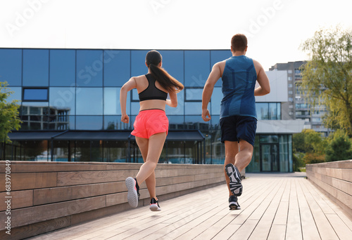 Healthy lifestyle. Couple running outdoors, low angle view