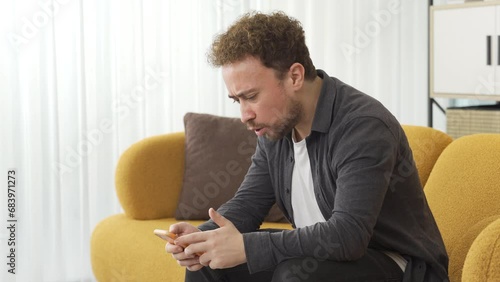 Young man angry with phone message. photo