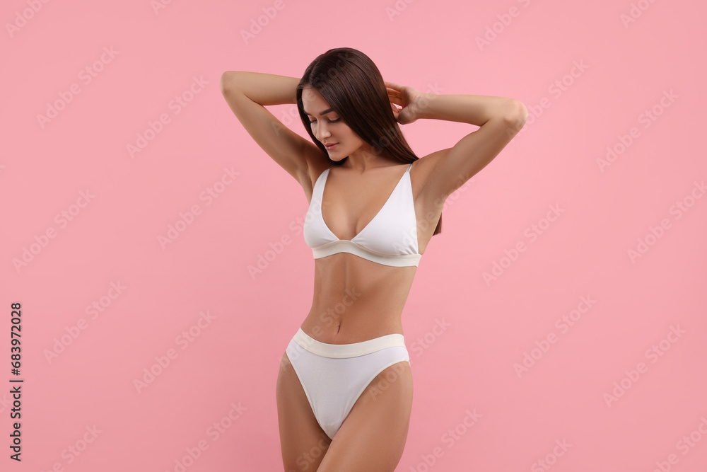 Obraz premium Young woman in stylish white bikini on pink background