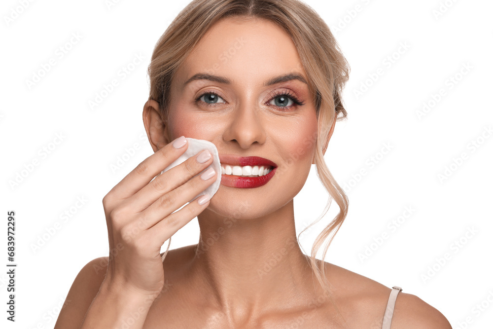 Smiling woman removing makeup with cotton pad on white background Smiling woman removing makeup with cotton pad on white background