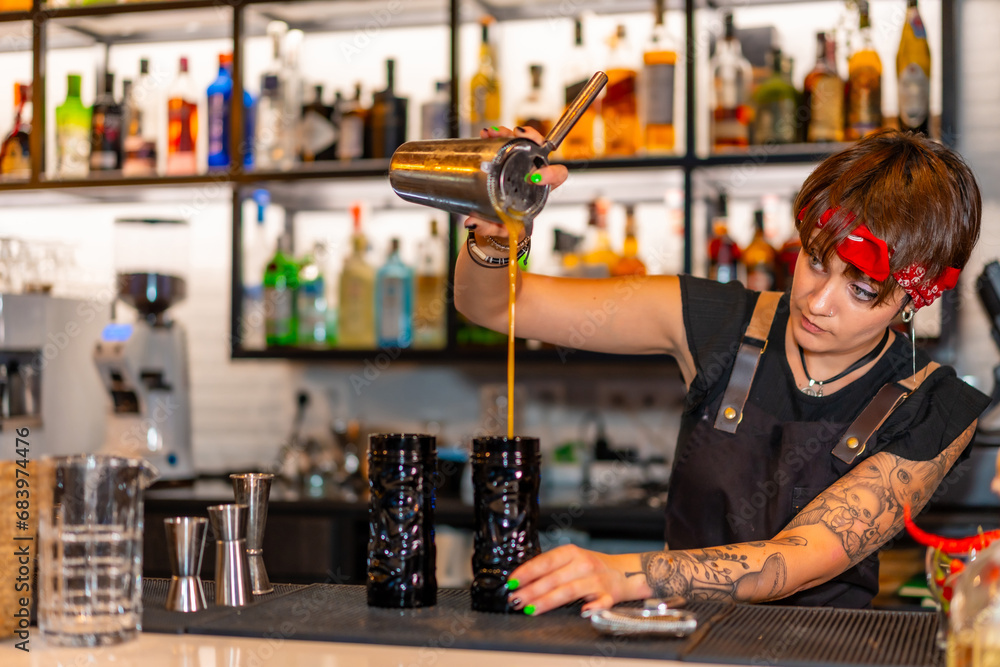 Young alternative professional bartender working on a bar