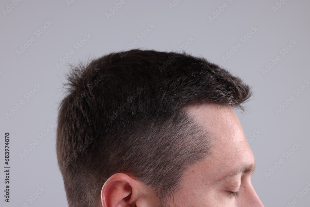 Man with healthy hair on grey background, closeup Man with healthy hair on grey background, closeup
