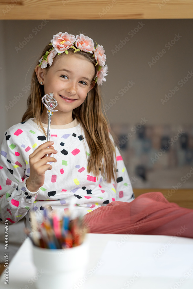 happy little girl in her play room making fun toy colours laugh
