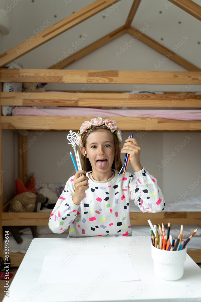 happy little girl in her play room making fun toy colours laugh