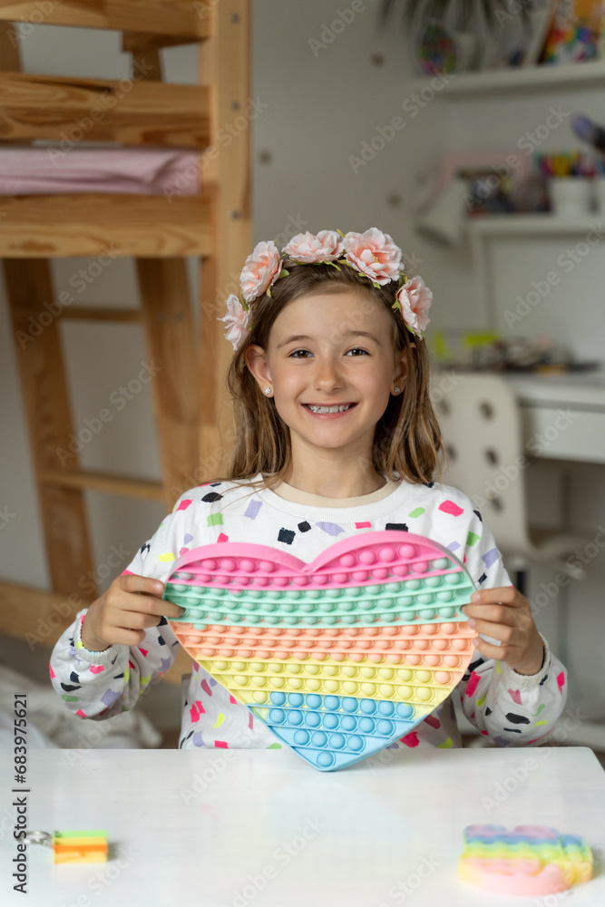 happy little girl in her play room trendy toy squishy smile