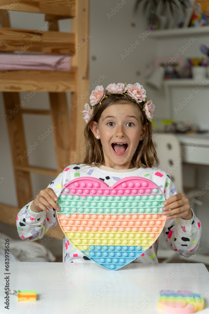 happy little girl in her play room trendy toy squishy smile