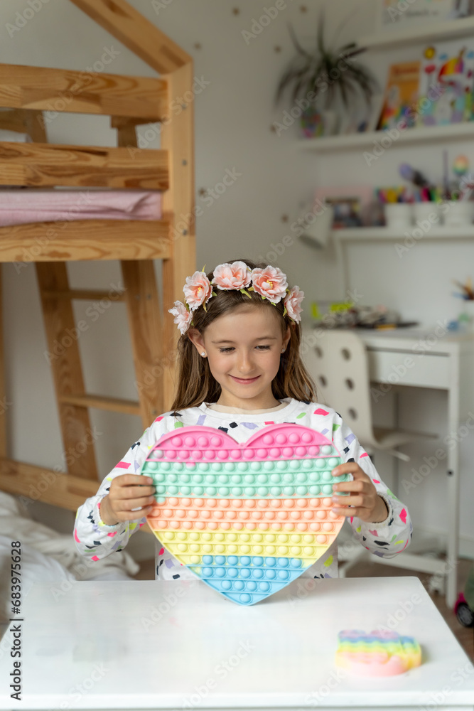 happy little girl in her play room trendy toy squishy smile