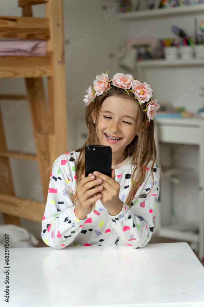 happy little girl in her play room smart phone addicted watching video video game expressions screaming