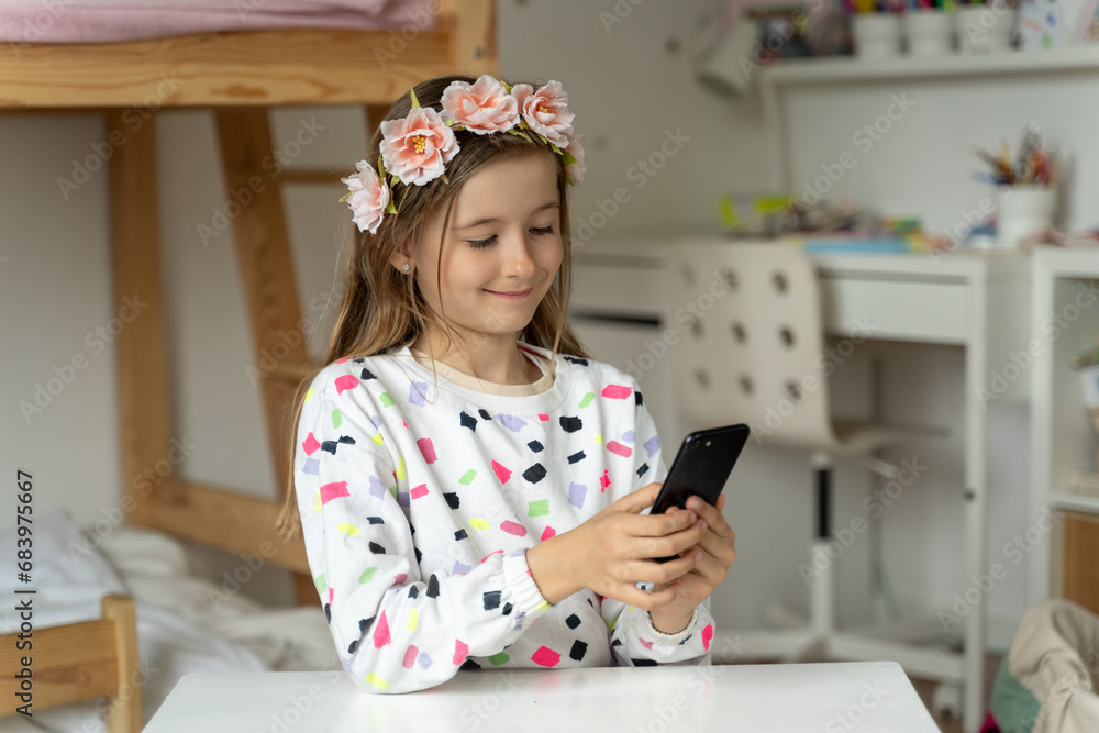 happy little girl in her play room smart phone addicted watching video video game expressions screaming
