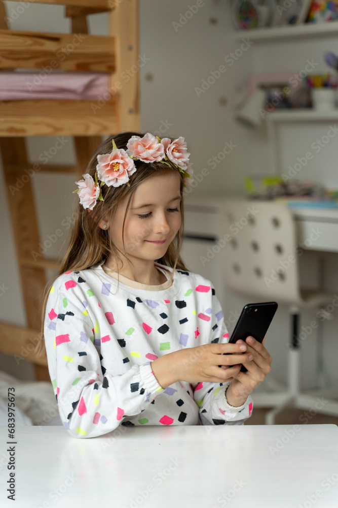 happy little girl in her play room smart phone addicted watching video video game expressions screaming