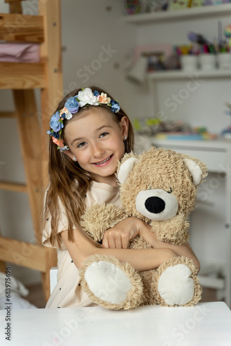 happy little girl in her play room with teddy bear hugs lonely, love, 