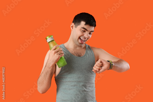 Sporty young man with water...