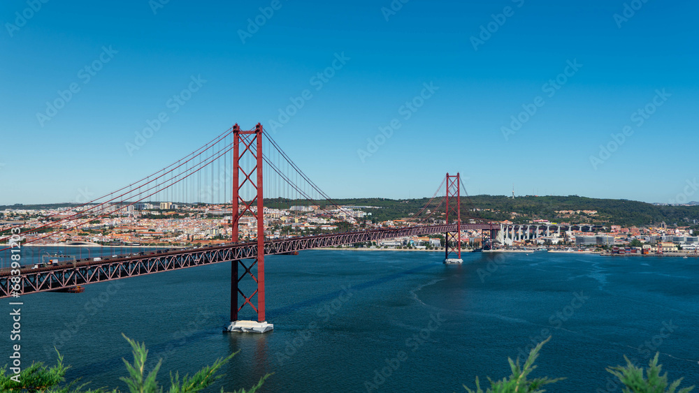 Fototapeta premium Lisbon, Portugal - 10.08.2023: 25th of April Bridge (Ponte 25 de Abril). View from Almada.