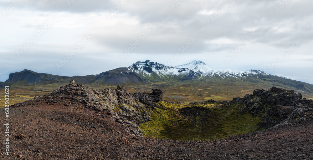 Spectacular volcanic view from Saxholl Crater, Snaefellsnes peninsula, West Iceland. Snaefellsjokull snowy volcano top in far. Spectacular volcanic view from Saxholl Crater, Snaefellsnes peninsula, West Iceland. Snaefellsjokull snowy volcano top in far.