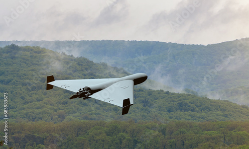 Russian military kamikaze drone Shahed flying in the clouds over mountain peyosage, Iranian combat drone in the sky, war in Ukraine, 