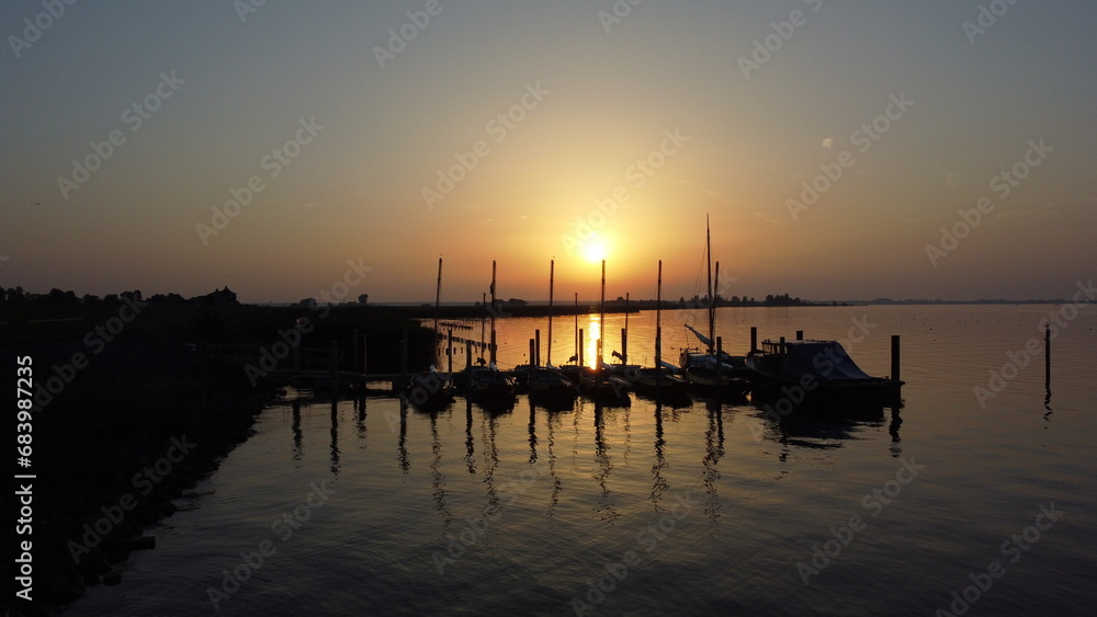 Sunset over water with boats