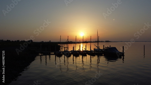 Sunset over water with boats