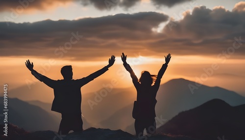 silhouette of a people with arms raised up to the sky, standing on a mountain, symbolic success, success concept