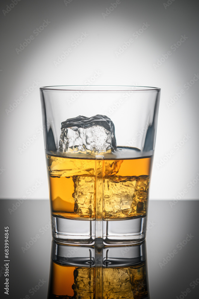 glass of Scotch whiskey with ice on white background 2