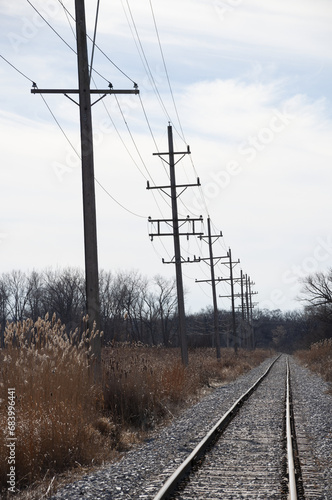 Single Track Railroad With Telecom Poles Into The Distance