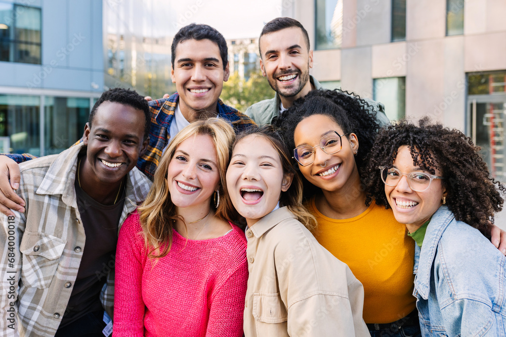 Portrait of young group of diverse people smiling at camera outdoors. Happy millennial college students enjoying time together, social gathering and hanging out at city street. Portrait of young group of diverse people smiling at camera outdoors. Happy millennial college students enjoying time together, social gathering and hanging out at city street.
