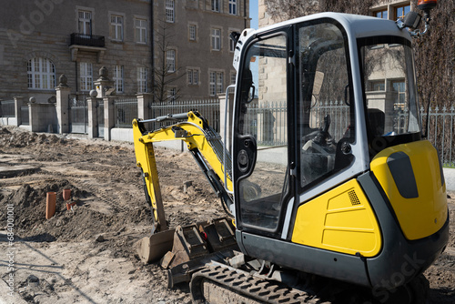 Construction Excavator Performs Road Repair Work On Street