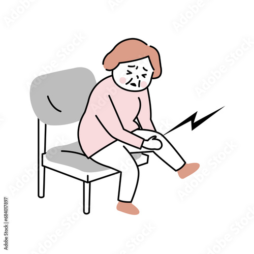 膝が痛んでさする椅子に座った女性