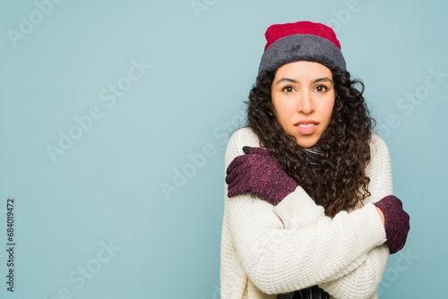 Beautiful woman with winter clothes feeling cold photo