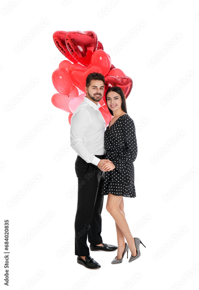 Happy young couple with heart shaped balloons isolated on white. Valentine's day celebration Happy young couple with heart shaped balloons isolated on white. Valentine's day celebration