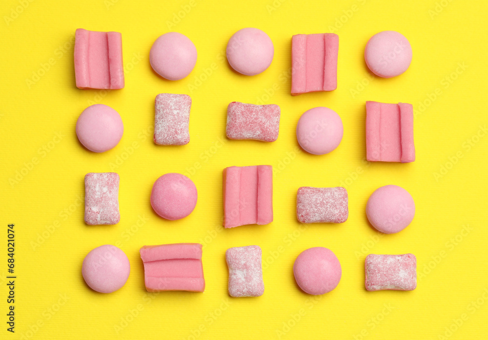 Pink bubble gums on yellow background, flat lay Pink bubble gums on yellow background, flat lay
